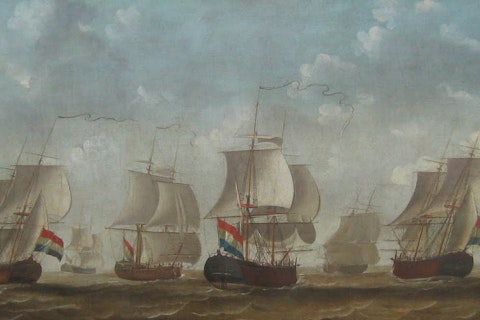 Acht schepen van een type zeilen bijna naast elkaar.
